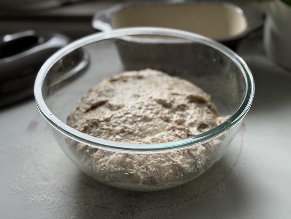 Haferbrot Rezept – Teig nach der Gehzeit Aufgegangener Haferbrot-Teig in einer Glasschüssel, im Hintergrund der Kleine Ofenmeister von Pampered Chef®